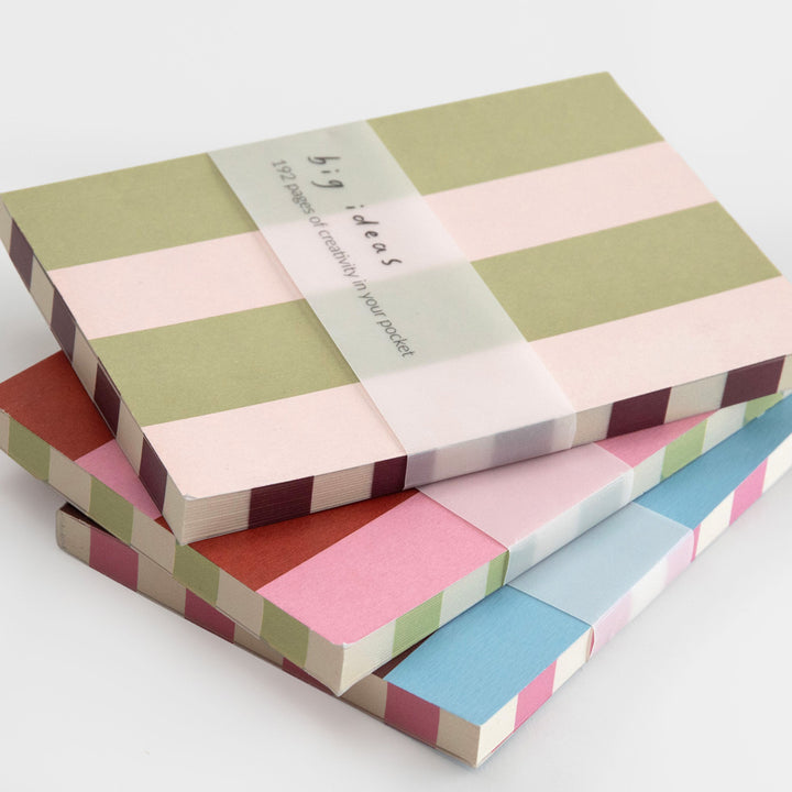 Three striped paper pocket folders stacked on a white background, wrapped in a clear band that reads 'big ideas 120 sheets of colorful paper pocket'.