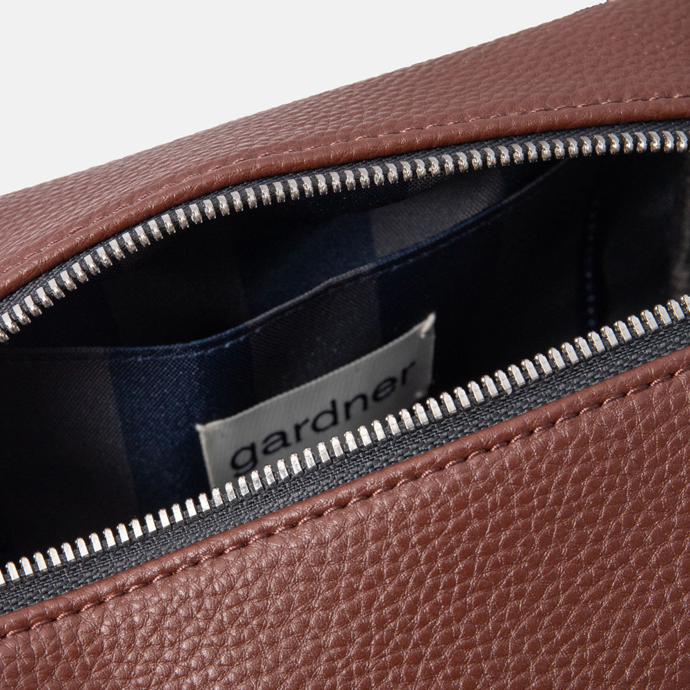 dark purple small ash bag with silver zip and blue and green internal lining