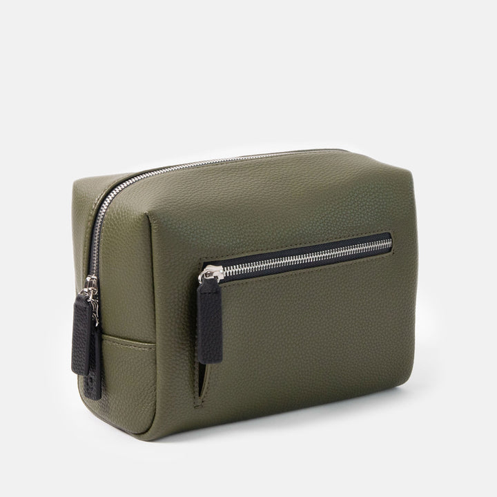 khaki green leather look wash bag with silver zip front pocket and main compartment on a white background