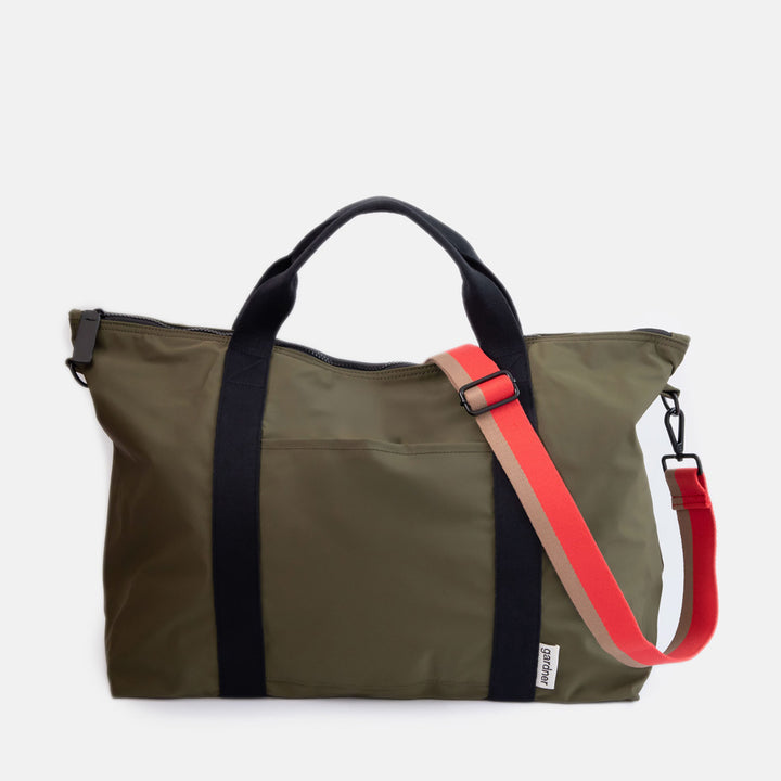 dark green weekend travel bag with black grab handles and a red & sand stripe shoulder strap
