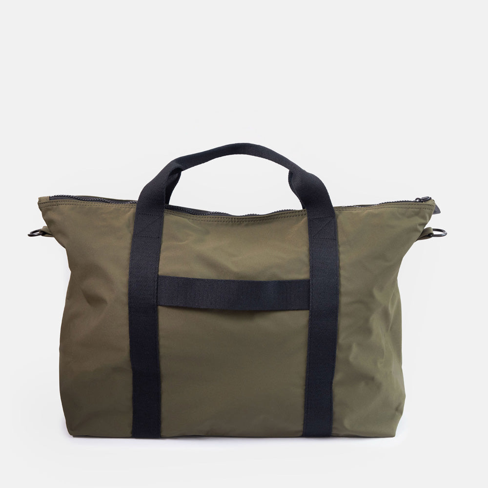 dark green weekend travel bag with black grab handles and suitcase strap