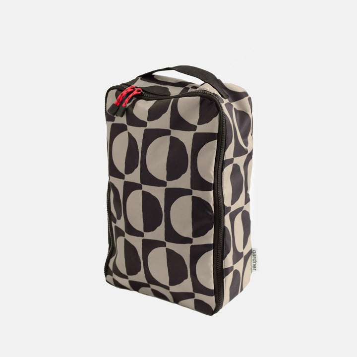 black & white geometric circles design shoe bag on a white background