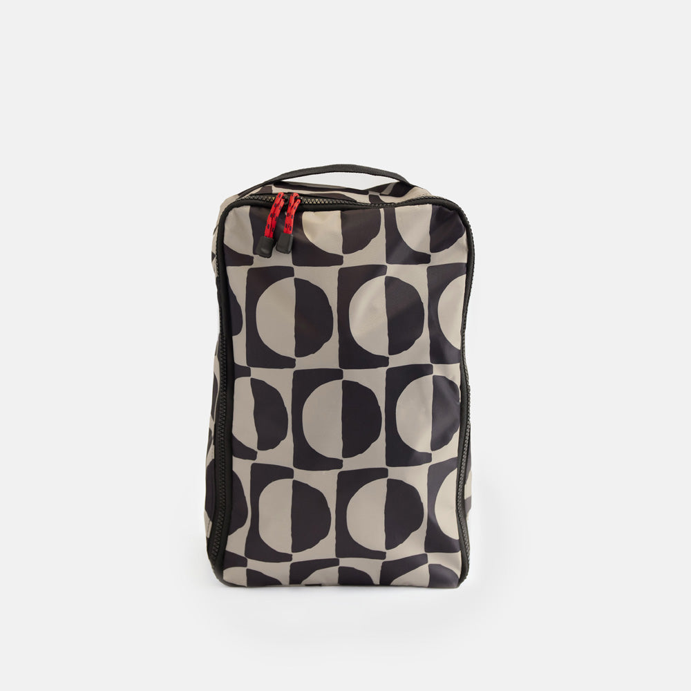 black & white geometric circles design shoe bag on a white background