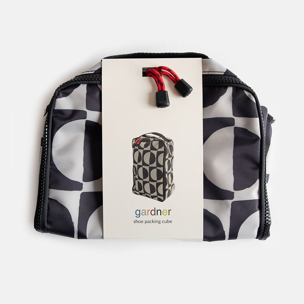 packaged caroline gardner black & white geometric circles design shoe bag on a white background