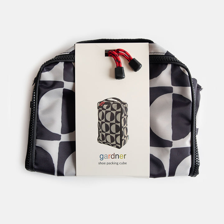 packaged caroline gardner black & white geometric circles design shoe bag on a white background