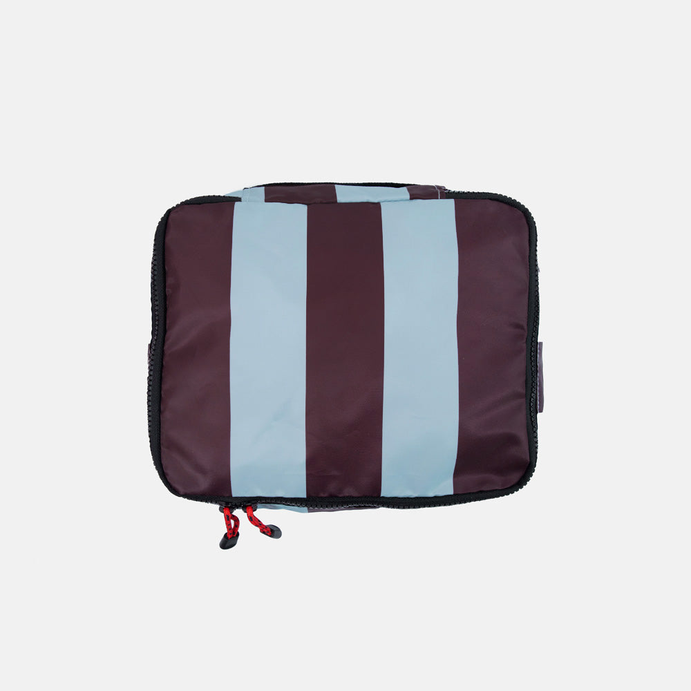 Striped packing cube with dark purple and light blue stripe pattern on a white background