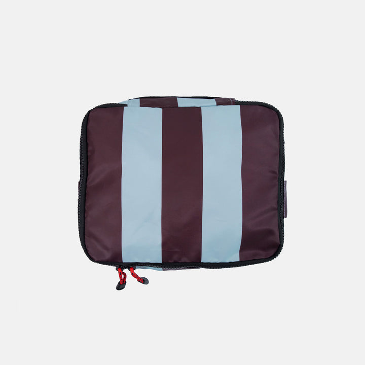 Striped packing cube with dark purple and light blue stripe pattern on a white background