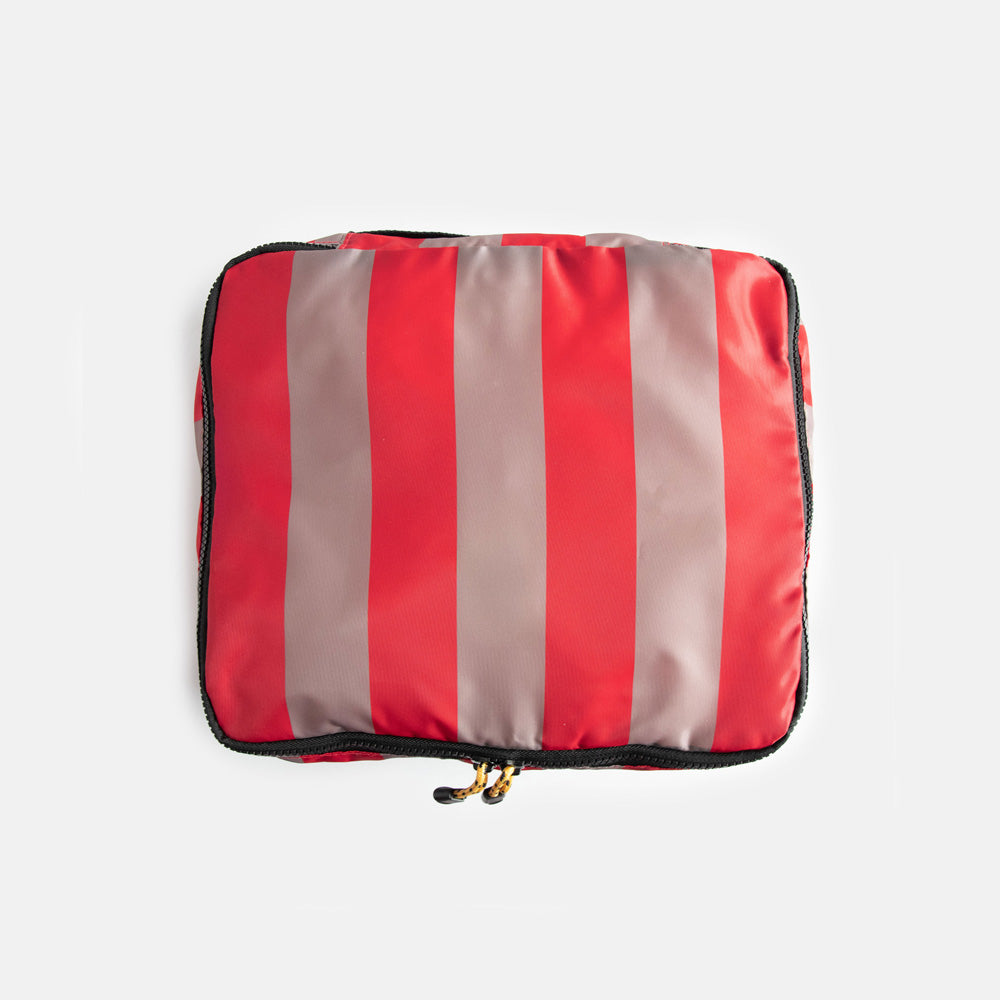 Striped packing cube with red and beige stripe pattern on a white background