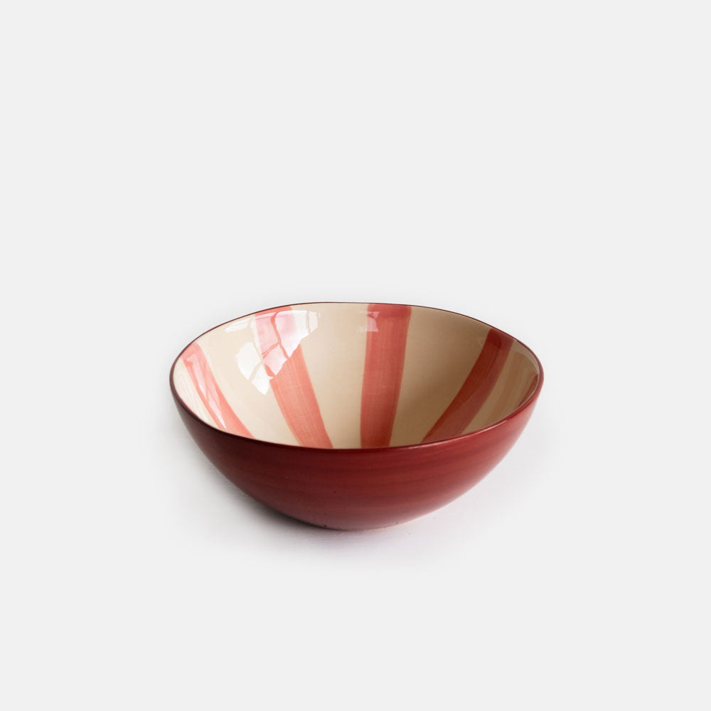 hand made ceramic bowl with pink candy stripes on inside and hand painted paprika red outside