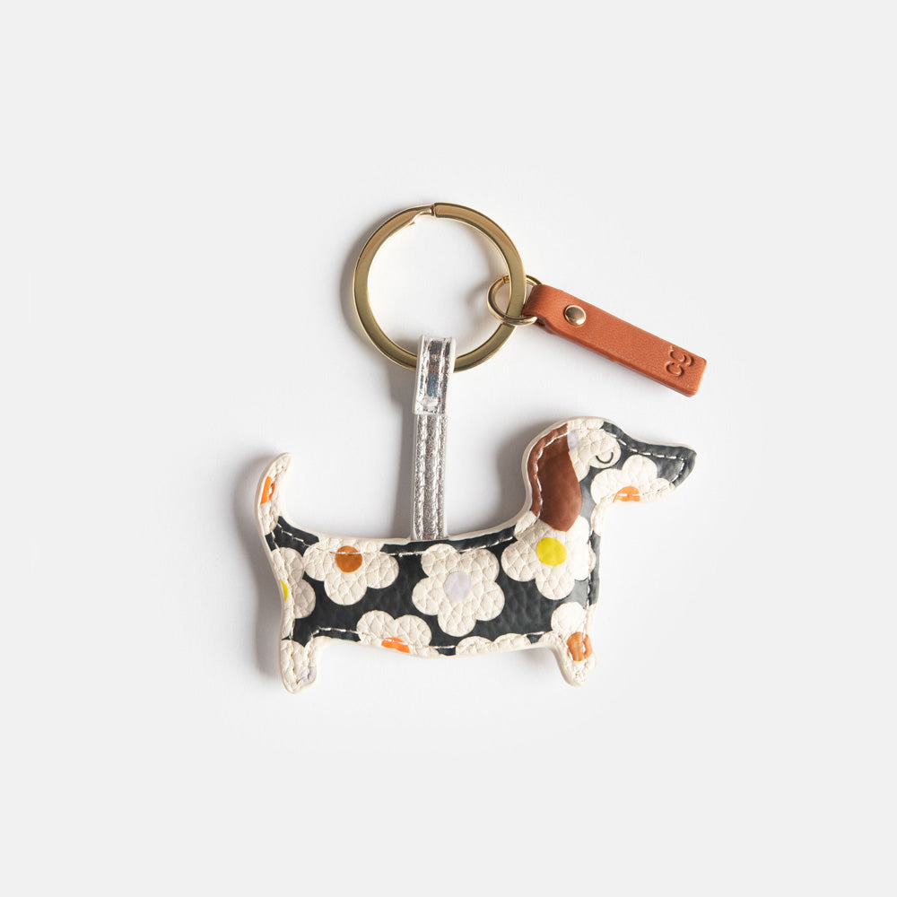 padded dog shaped keyring in colourful floral print on a black base