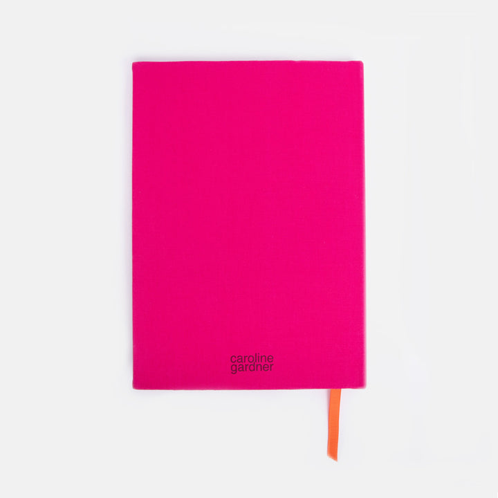 Pink notebook with orange marker ribbon on a white background