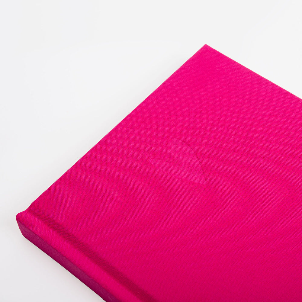 Close-up of a pink fabric notebook with a heart shape on a white background