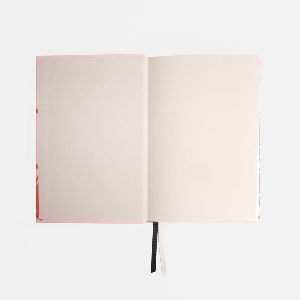 Open notebook with cream pages on a white background