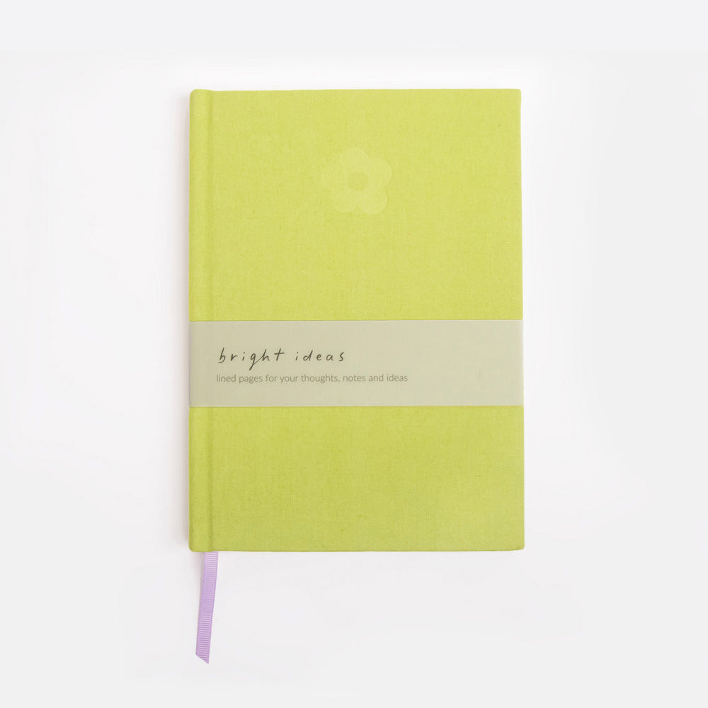 Green notebook with a debossed flower design on a white background