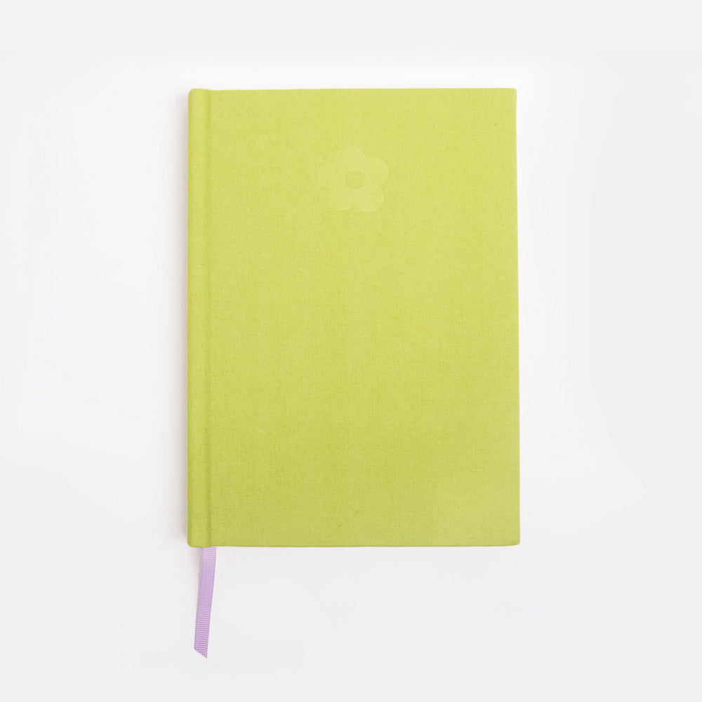 Green notebook with a debossed flower design on a white background