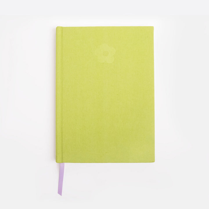 Green notebook with a debossed flower design on a white background