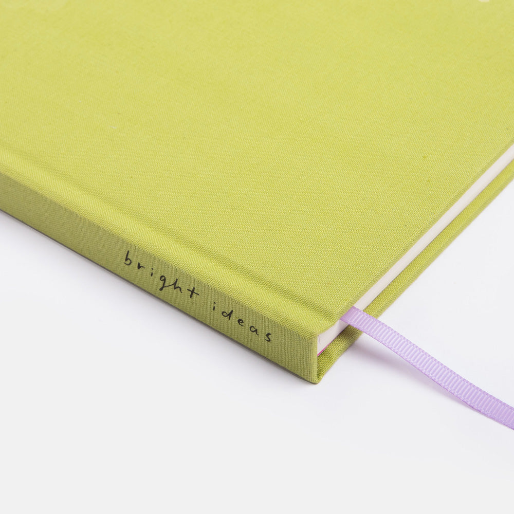 Green notebook with 'bright ideas' text on a white background