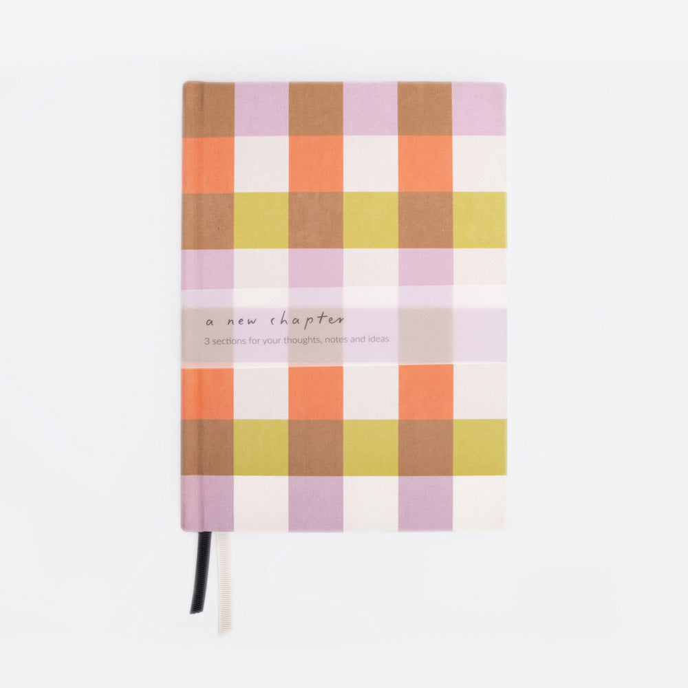 Checkered notebook with pastel colors on a white background
