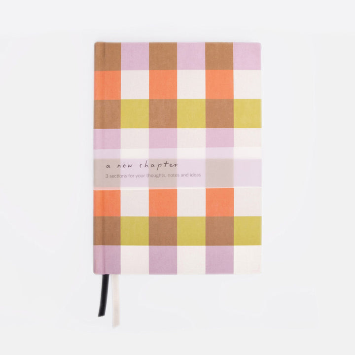 Checkered notebook with pastel colors on a white background