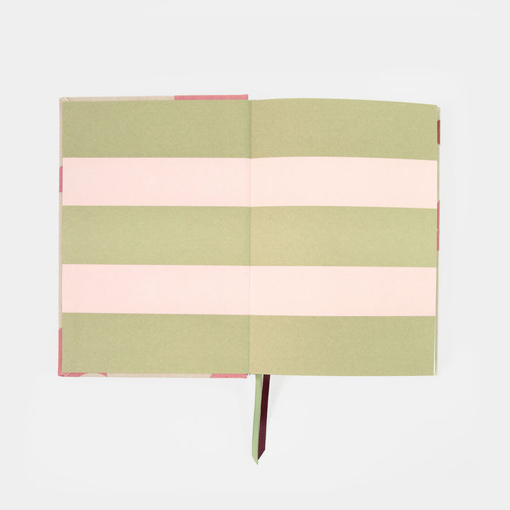 A hardcover notebook with alternating horizontal stripes of sage green and light pink, shown open on a clean white background.