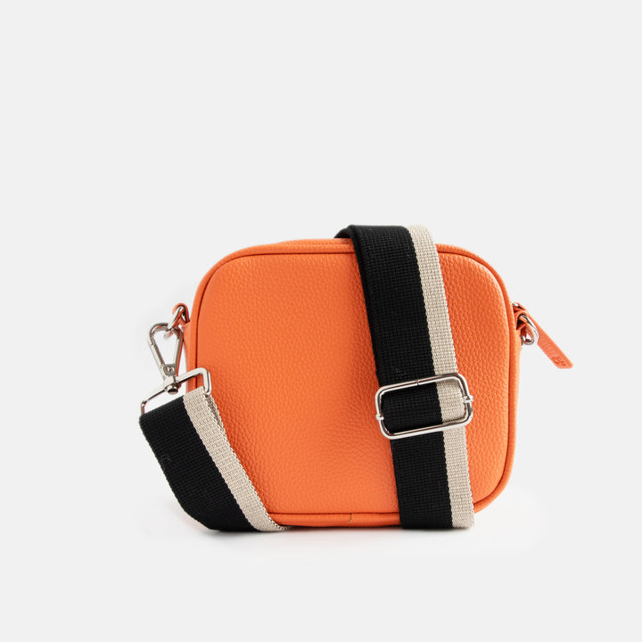 vegan leather orange camera bag with silver zip and hardware, monochrome webbing adjustable straps and spot print lining