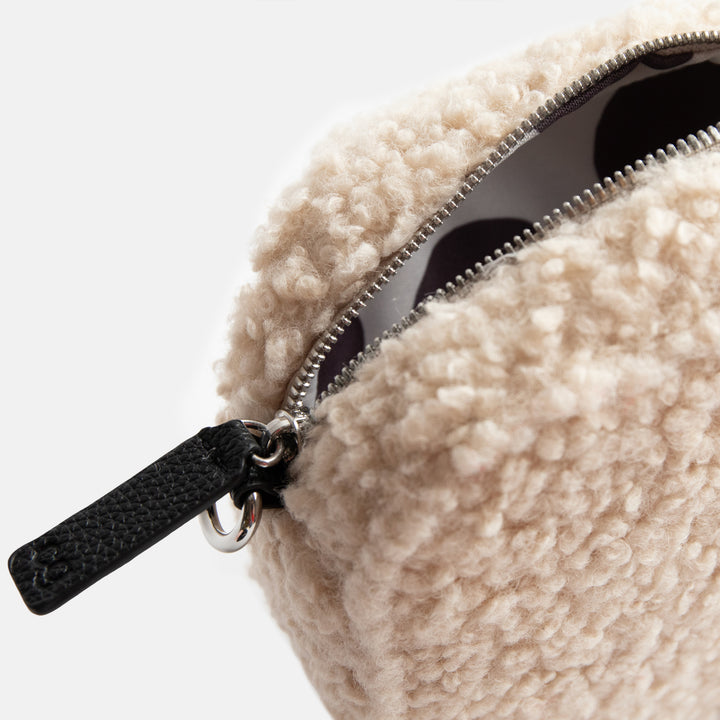 cream synthetic borg camera bag with silver zip and hardware, monochrome webbing adjustable straps and spot print lining