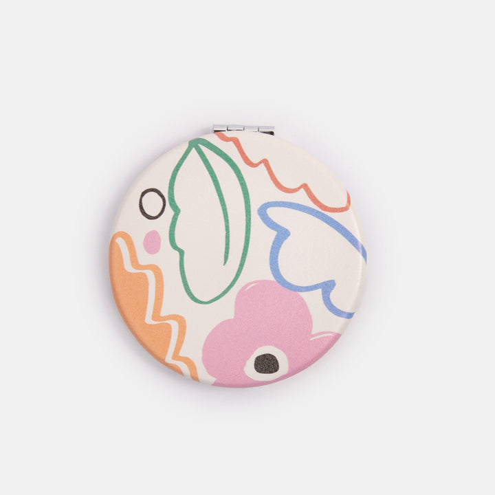 printed leather look PU round compact pocket mirror in colourful botanicals print, with 2 mirrors and magnetic fastening