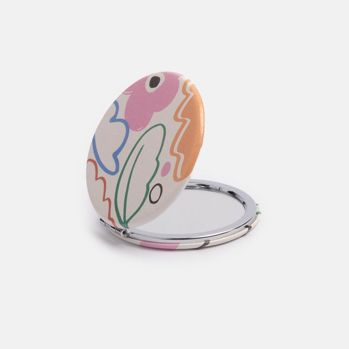 printed leather look PU round compact pocket mirror in colourful botanicals print, with 2 mirrors and magnetic fastening