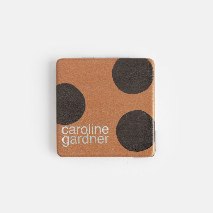 printed leather look PU square compact pocket mirror in a black and white spot print on the pront and black and brown spot on the back, with 2 mirrors and magnetic fastening