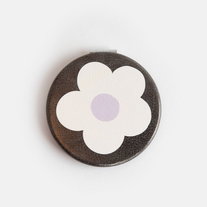printed leather look PU round compact pocket mirror in a cream flower over charcoal print, with 2 mirrors and magnetic fastening