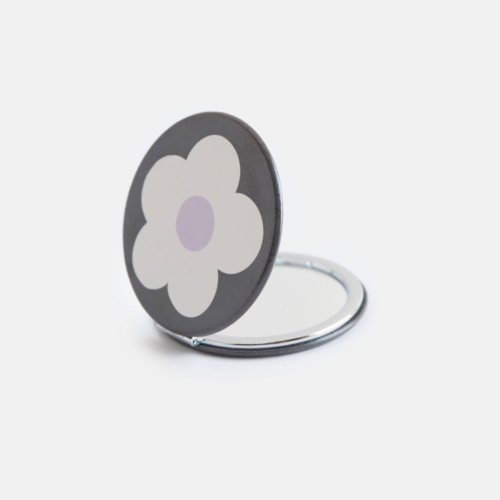 printed leather look PU round compact pocket mirror in a cream flower over charcoal print, with 2 mirrors and magnetic fastening