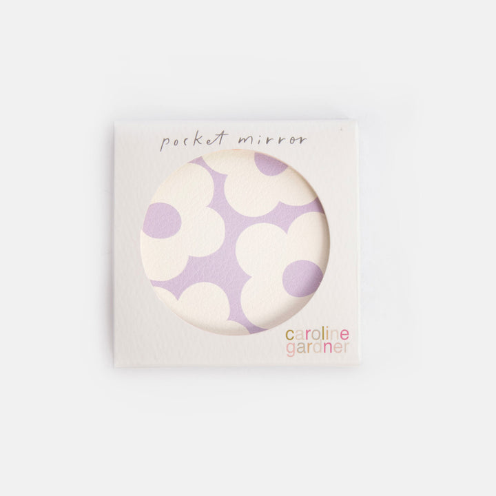 Pocket mirror with purple and white floral pattern in packaging on a white background