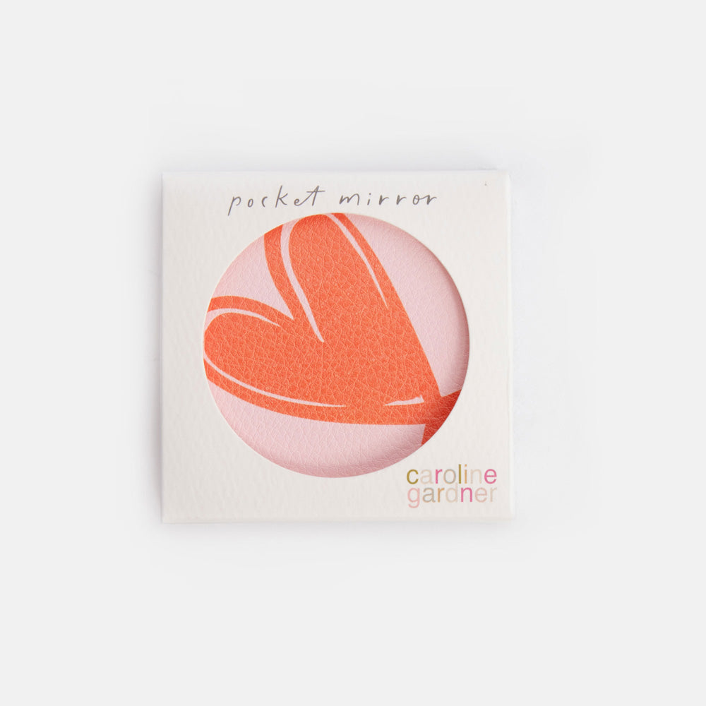 Pocket mirror with heart design on a white background