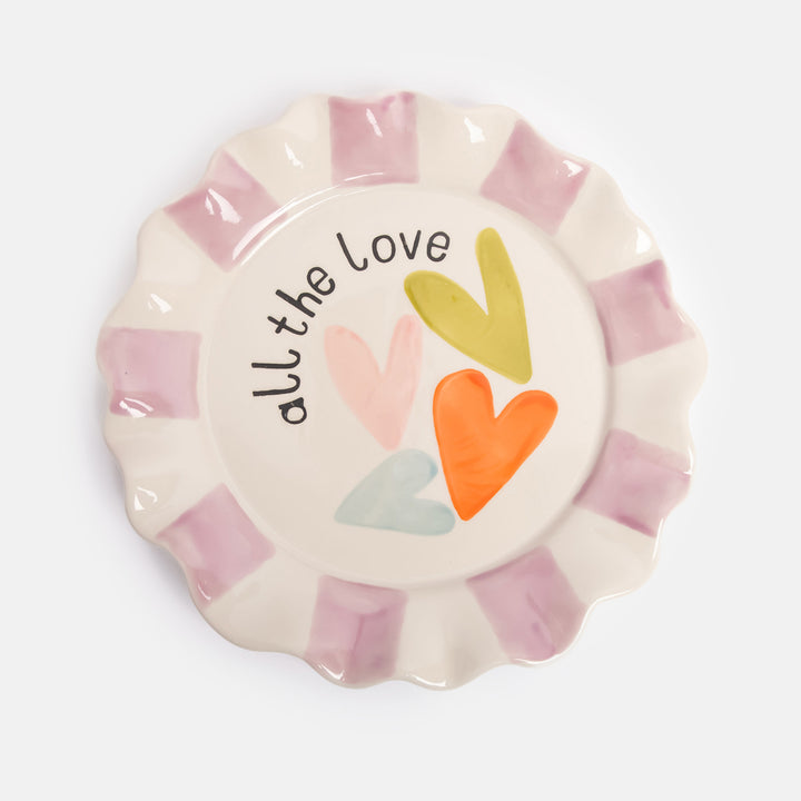 hand painted ceramic stoneware plate with purple stripe scalloped rim and multi coloured heart design and all the love slogan