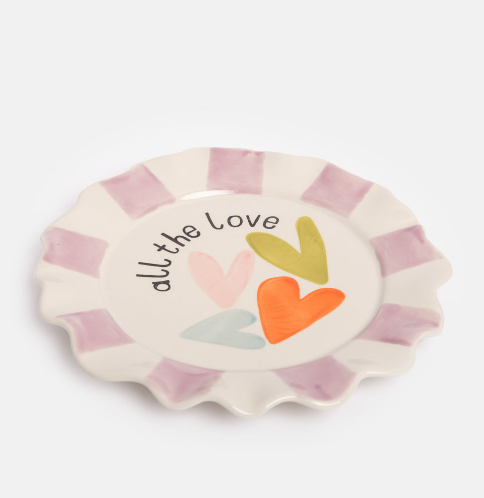 hand painted ceramic stoneware plate with purple stripe scalloped rim and multi coloured heart design and all the love slogan