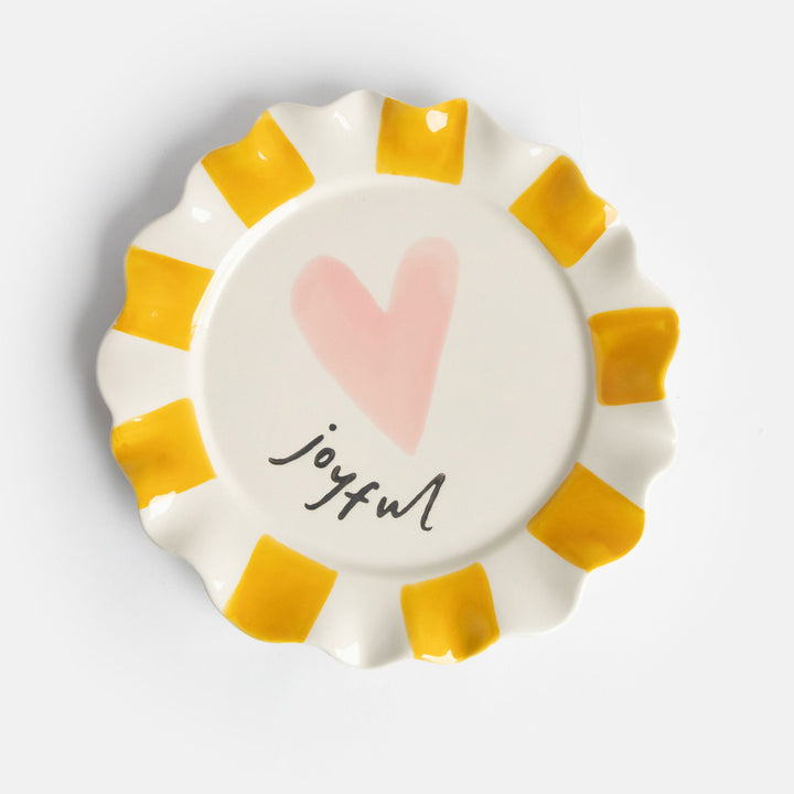 ceramic stoneware plate with hand painted mustard stripe scalloped edges, pink heart and "joyful" slogan  