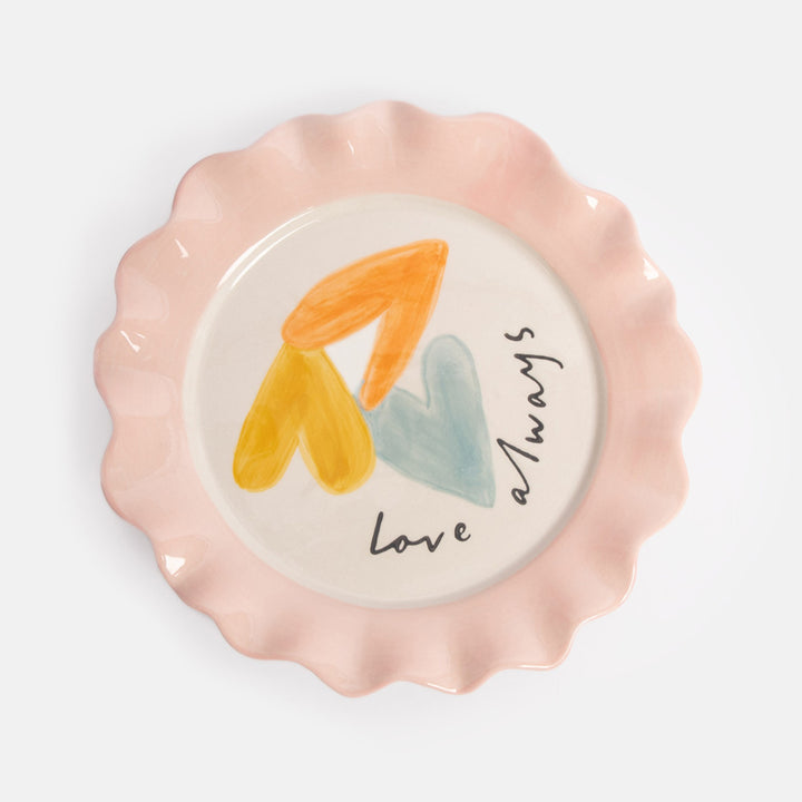 white ceramic plate featuring 3 colourful overlapping hearts and the text 'love always' and finished with a pink scalloped edge rim