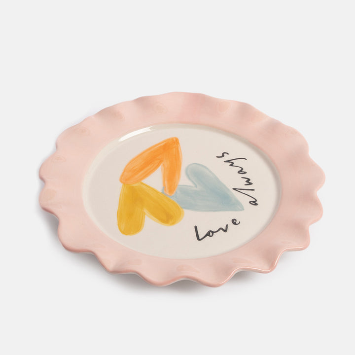 white ceramic plate featuring 3 colourful overlapping hearts and the text 'love always' and finished with a pink scalloped edge rim