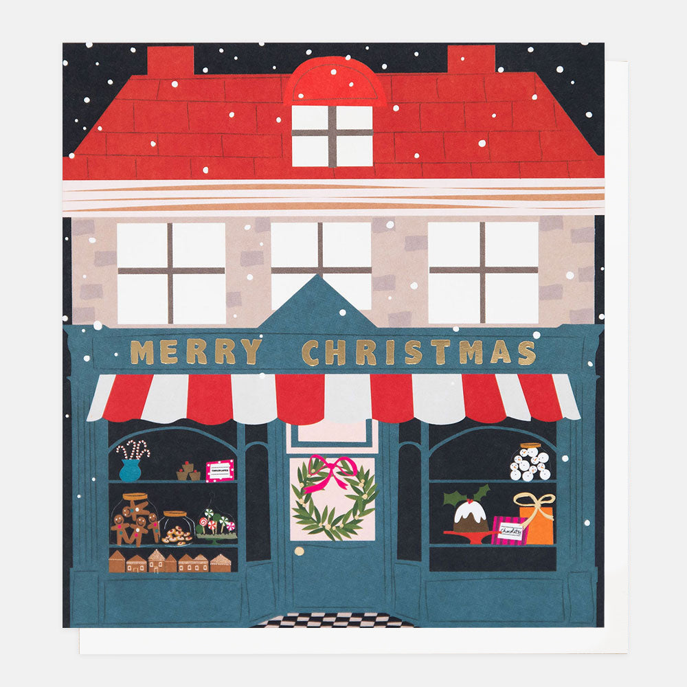 Christmas card with an Illustration of a festive store front with 'Merry Christmas' sign and snowy roof.