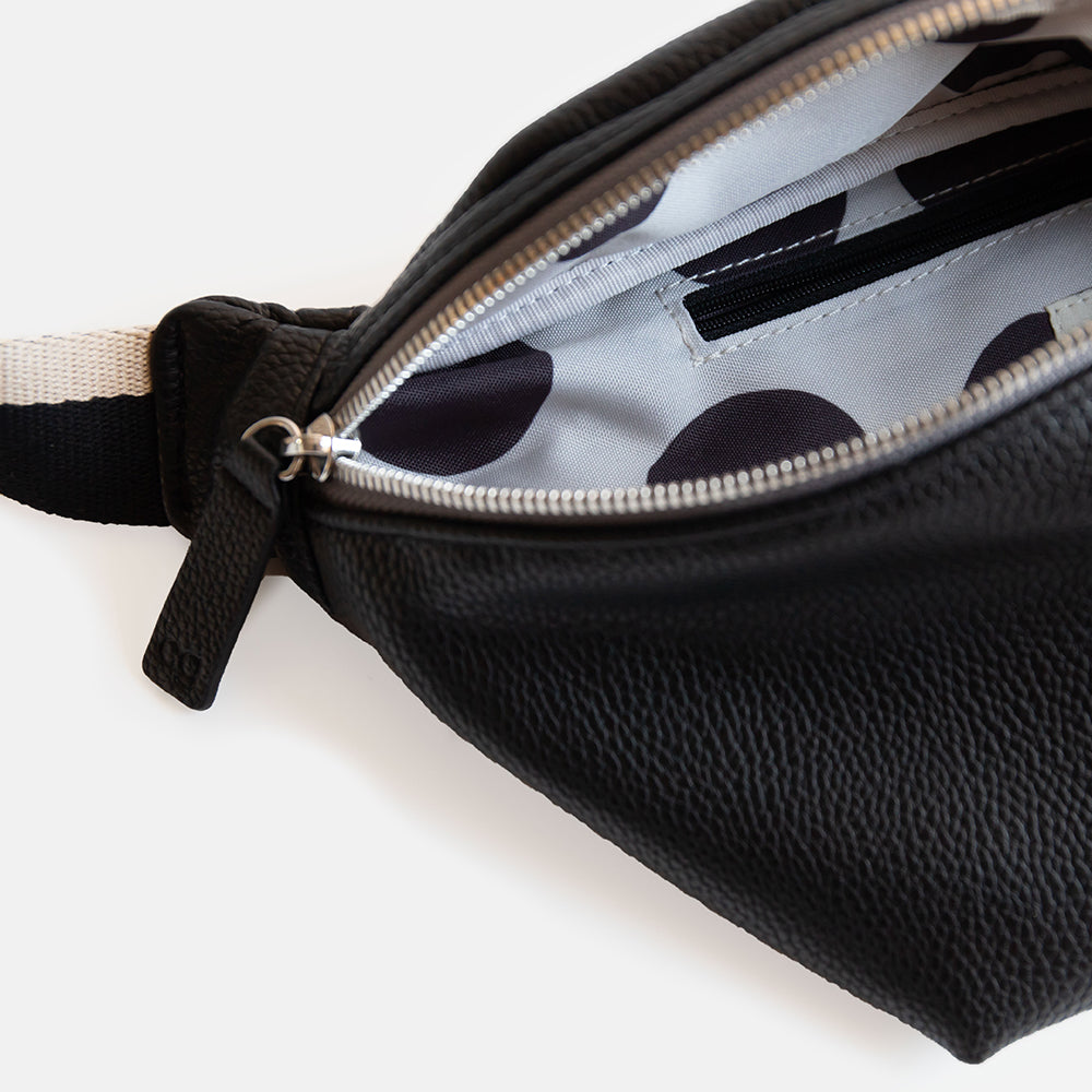 black vegan leather crossbody bag with black spot lining on white background