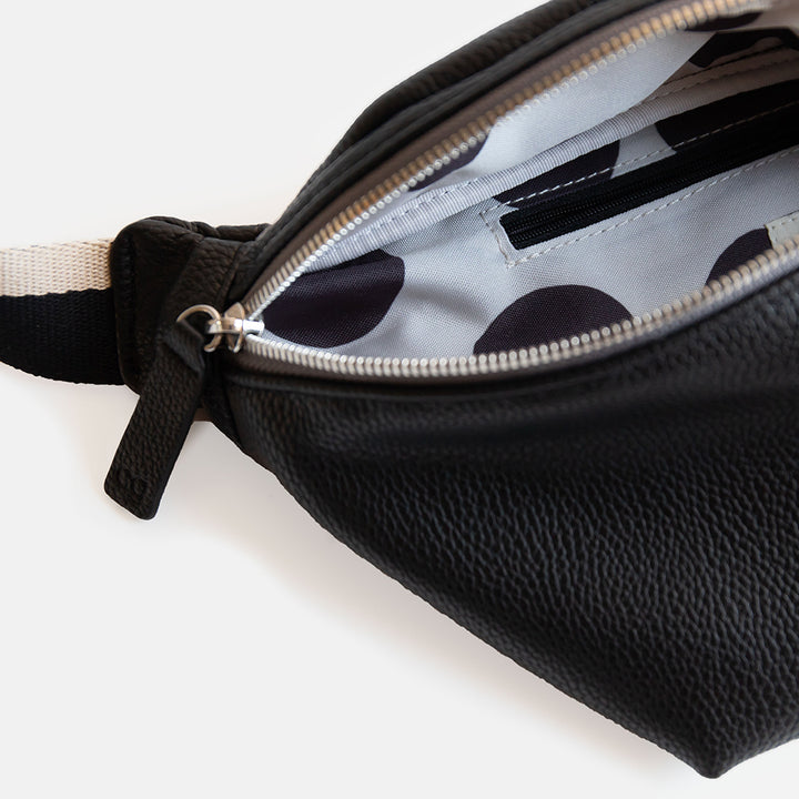 black vegan leather crossbody bag with black spot lining on white background