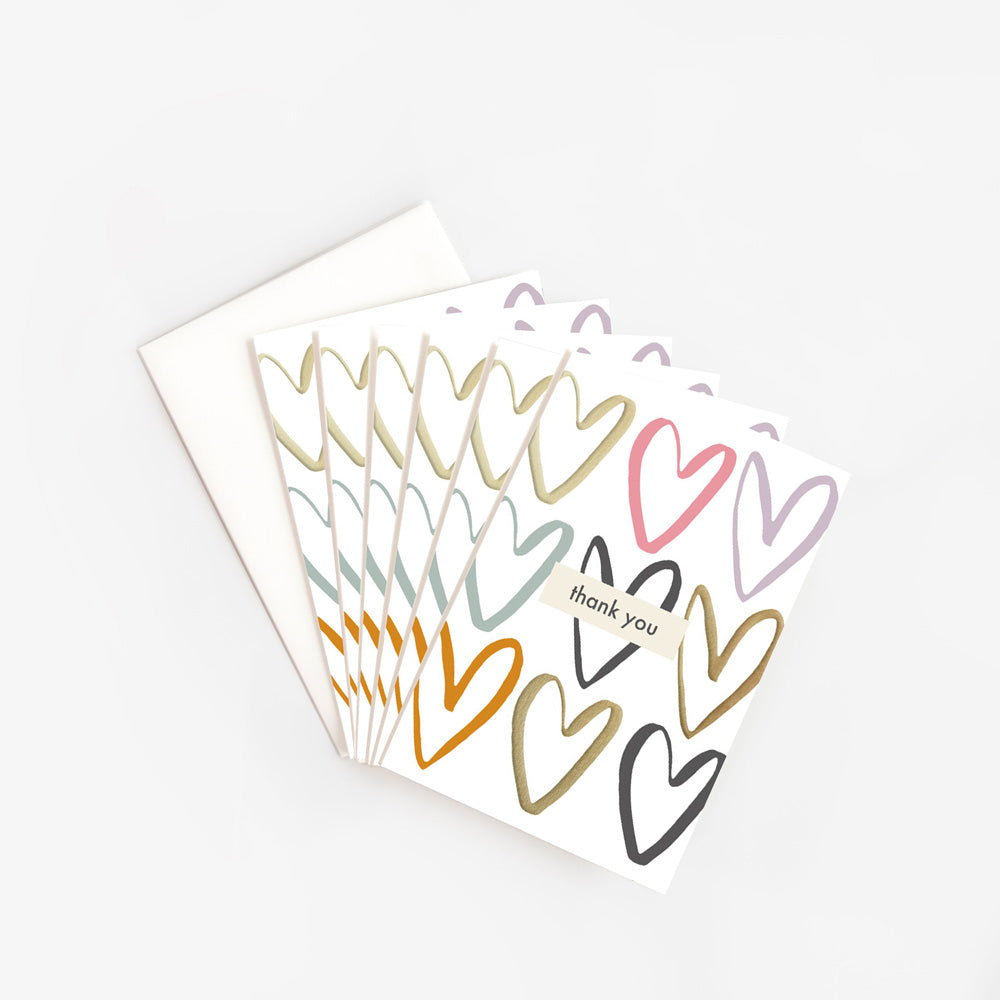 pack of 6 thank you cards featuring multi coloured outline hearts and the text 'thank you' in a central box