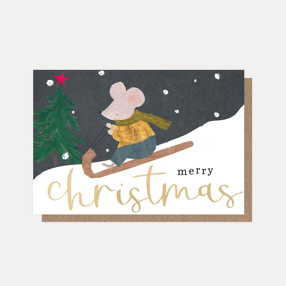 christmas card featuring a snowy night time scene with a hand drawn mouse sledging downhill