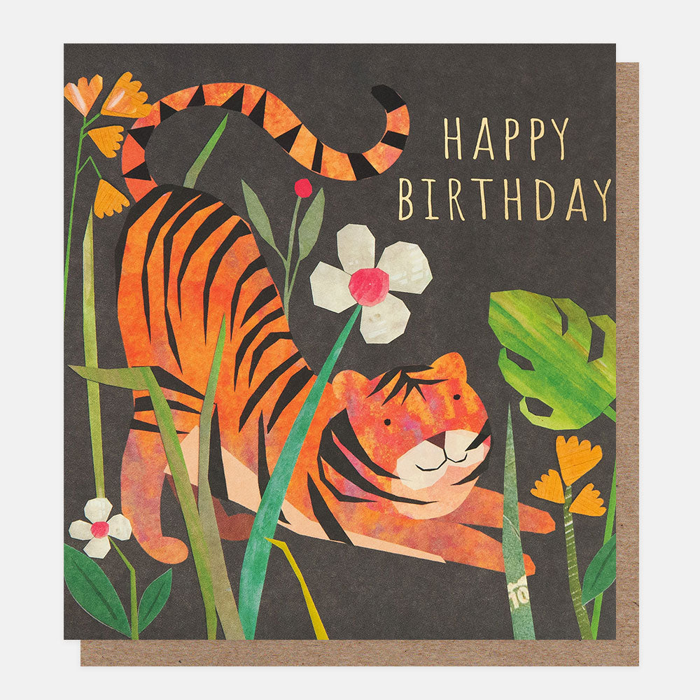 birthday card featuring a tiger amongst plants on a dark background and the words happy birthday in gold foil