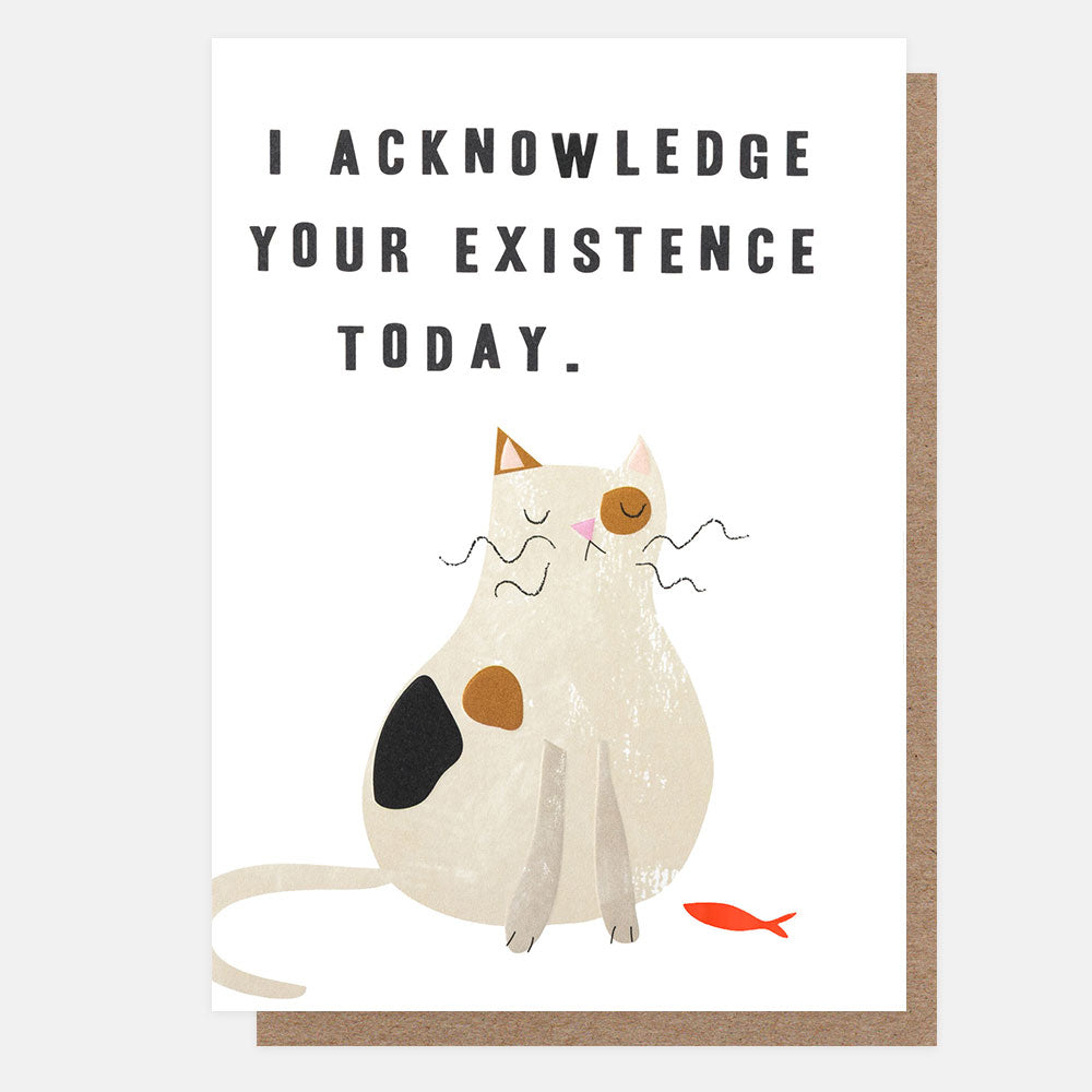 A greeting card with a white front featuring the text 'I ACKNOWLEDGE YOUR EXISTENCE TODAY.' above an illustration of a cream-colored cat with black and brown patches and a small orange fish, shown with a brown kraft envelope behind it.