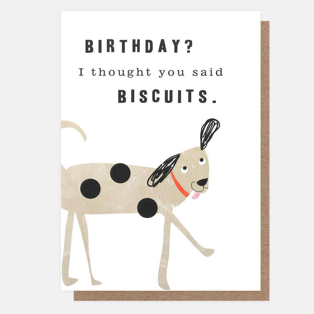 A birthday greeting card with a brown envelope behind it. The card has a white background with the text 'BIRTHDAY? I thought you said BISCUITS.
