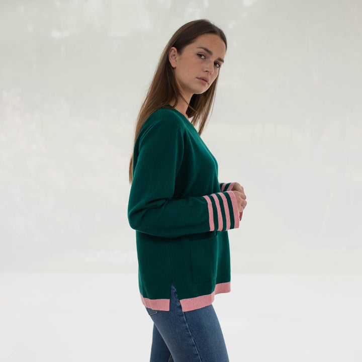 green pure cashmere crew neck jumper with pale pink waist trim and striped cuffs, made by Cocoa Cashmere