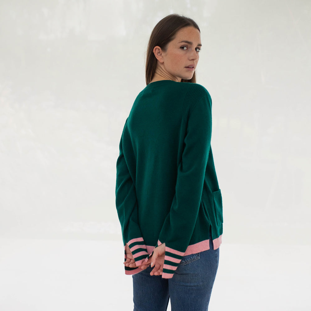 green pure cashmere crew neck jumper with pale pink waist trim and striped cuffs, made by Cocoa Cashmere