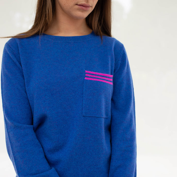 bright blue pure cashmere crew neck jumper with contrast pink stripe front pocket, made by Cocoa Cashmere