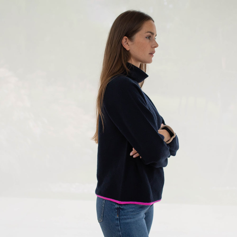 Navy Blue Pure Cashmere funnel neck Jumper with bright pink trim at the waist and camel trim at the wrist, made by Cocoa Cashmere